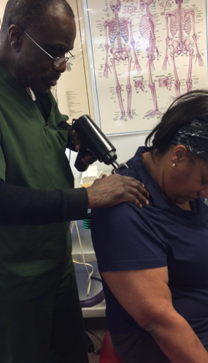 Houston chiropractor performing a shoulder adjustment